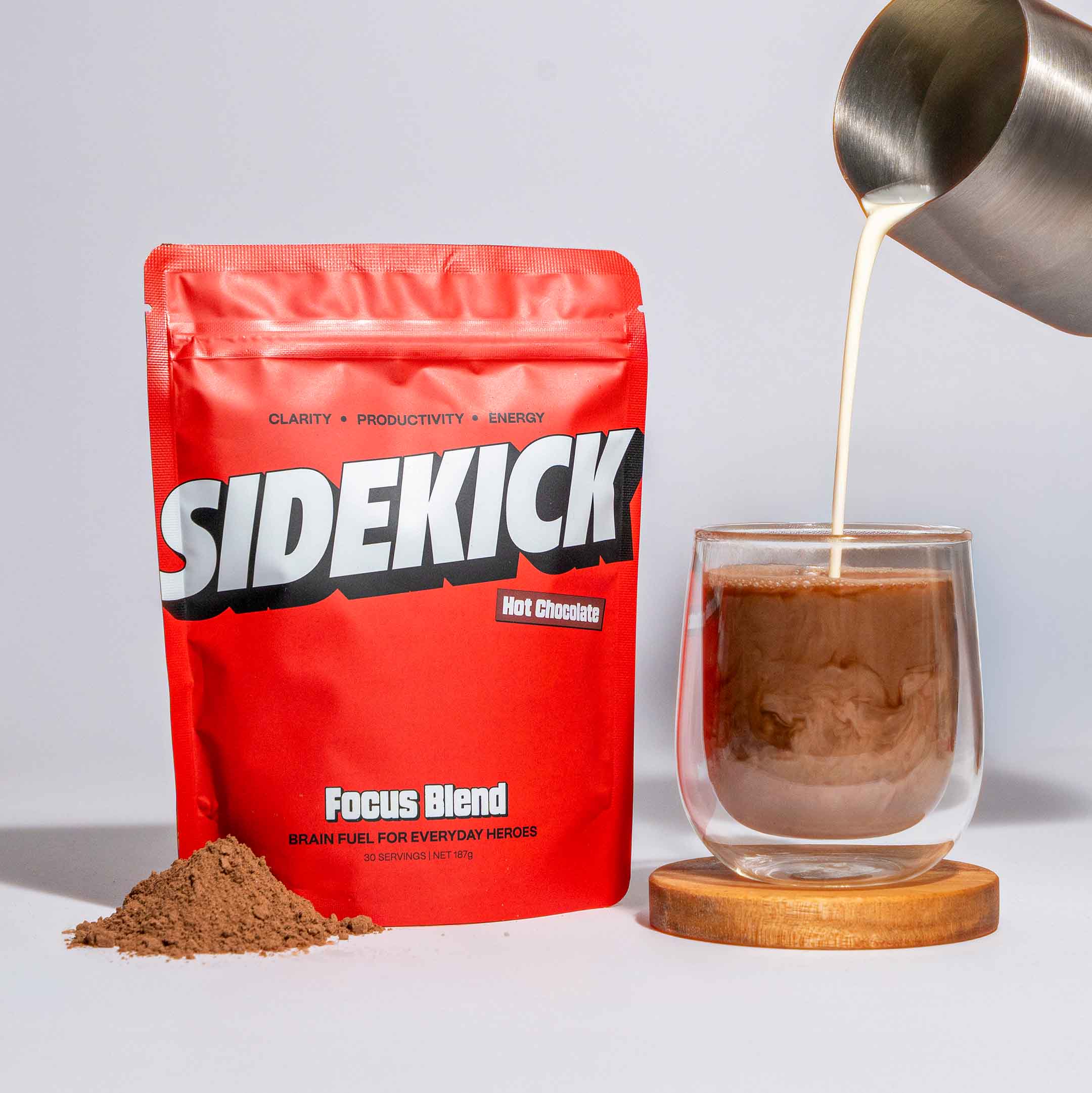 Red Sidekick focus blend packaging with a glass of hot chocolate being poured.